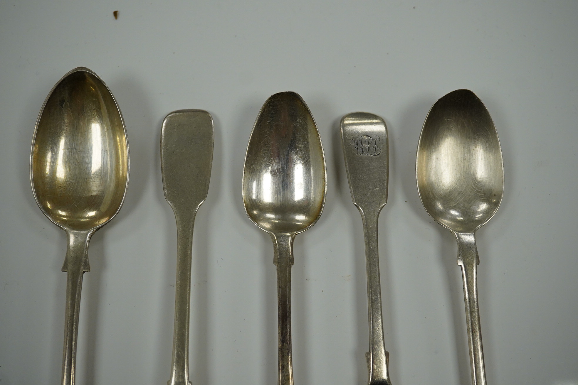 A harlequin set of thirty one William IV and later silver fiddle pattern tea spoons, various dates and makers, 20.9oz. Condition - poor to fair